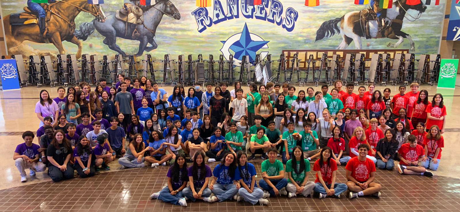 Students posing for picture after orchestra social in school cafeteria